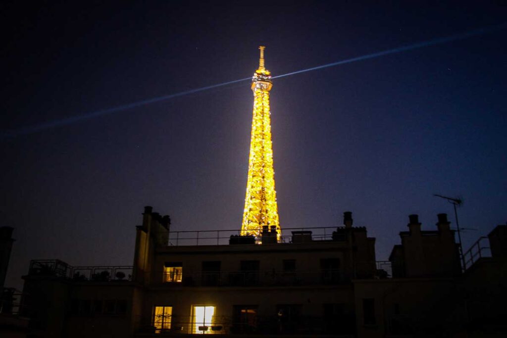 view of Eiffel Tower at night from our Paris Airbnb