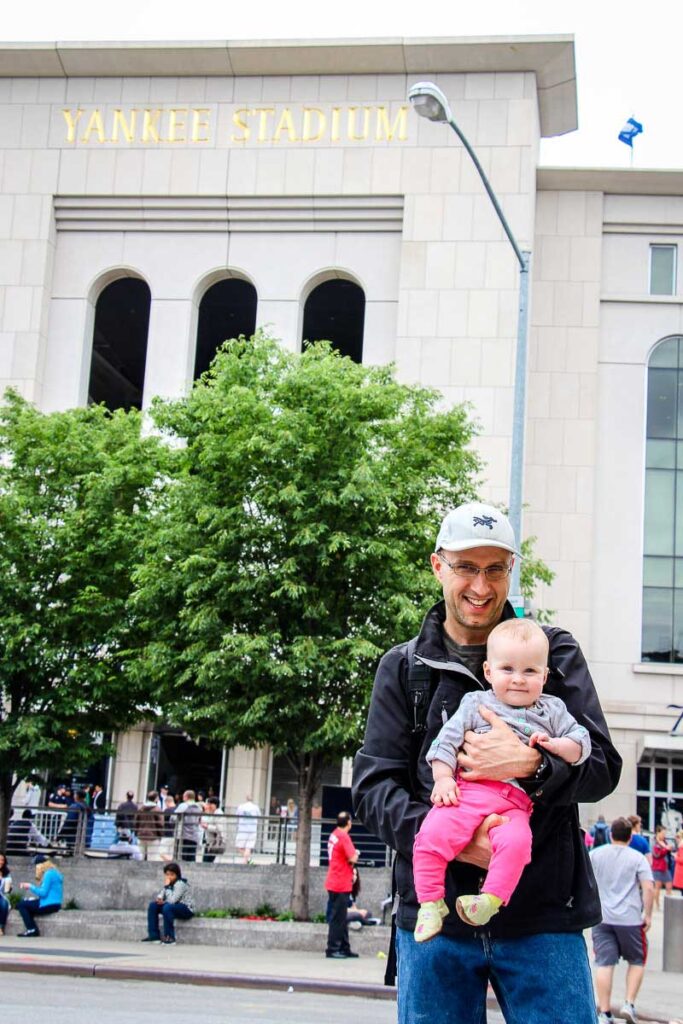 Holding a baby outside of Yankee Stadium in the Bronx