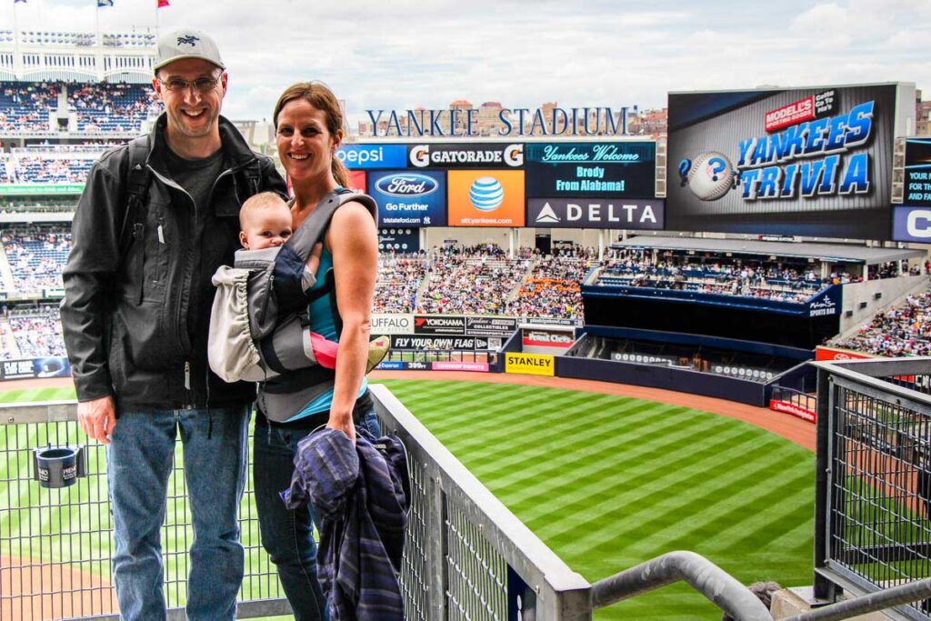 New York Yankees game with a baby in baby carrier