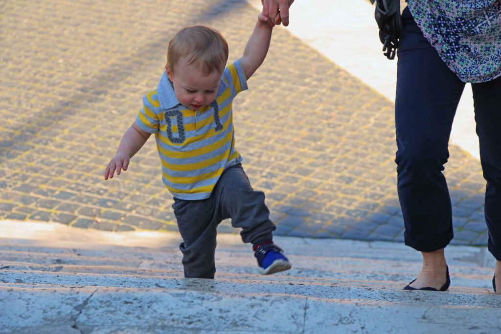 a toddler from the BabyCanTRavel.com family, slowly climbs the Spanish Steps in Rome, Italy.