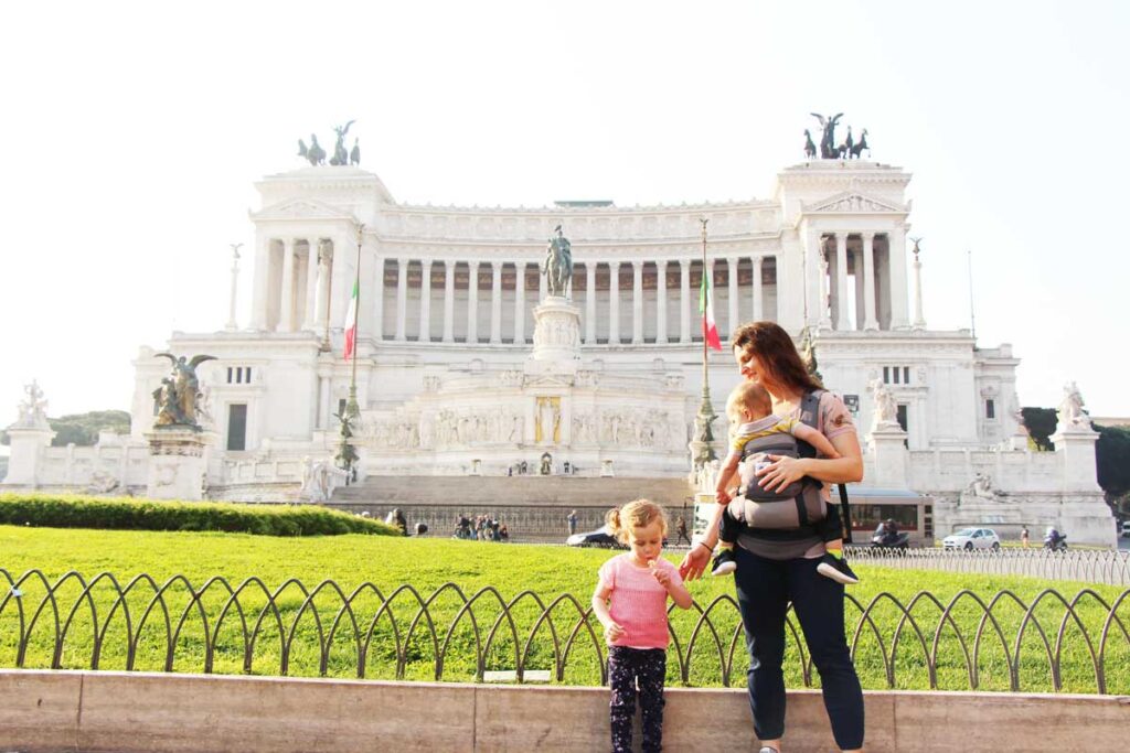 Celine Brewer, from the BabyCanTravel website, carries her toddler in front of the Monument to Victor Emmanuel II while on a family trip to Rome, Italy.