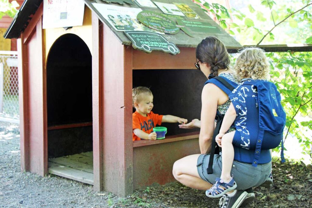 Celine Brewer, from the BabyCanTravel.com website, carries her daughter in a soft structured toddler carrier while on a family vacation.