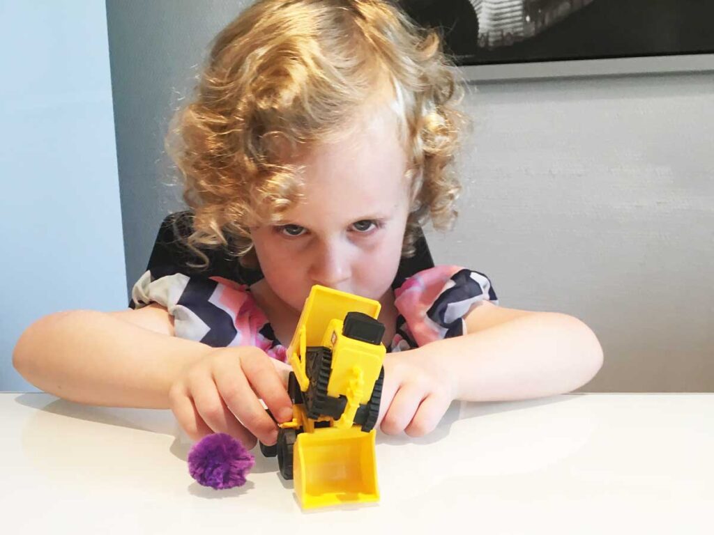 a toddler from the BabyCanTravel.com family plays with some simple travel toys while on a family vacation.