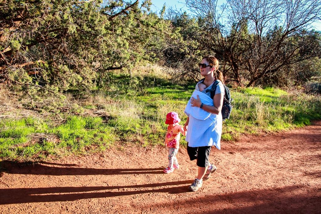 Celine Brewer, owner of Baby Can Travel, hikes the Baldwin Trail in Sedona with her walking toddler and her baby in a Baby K'Tan Wrap.