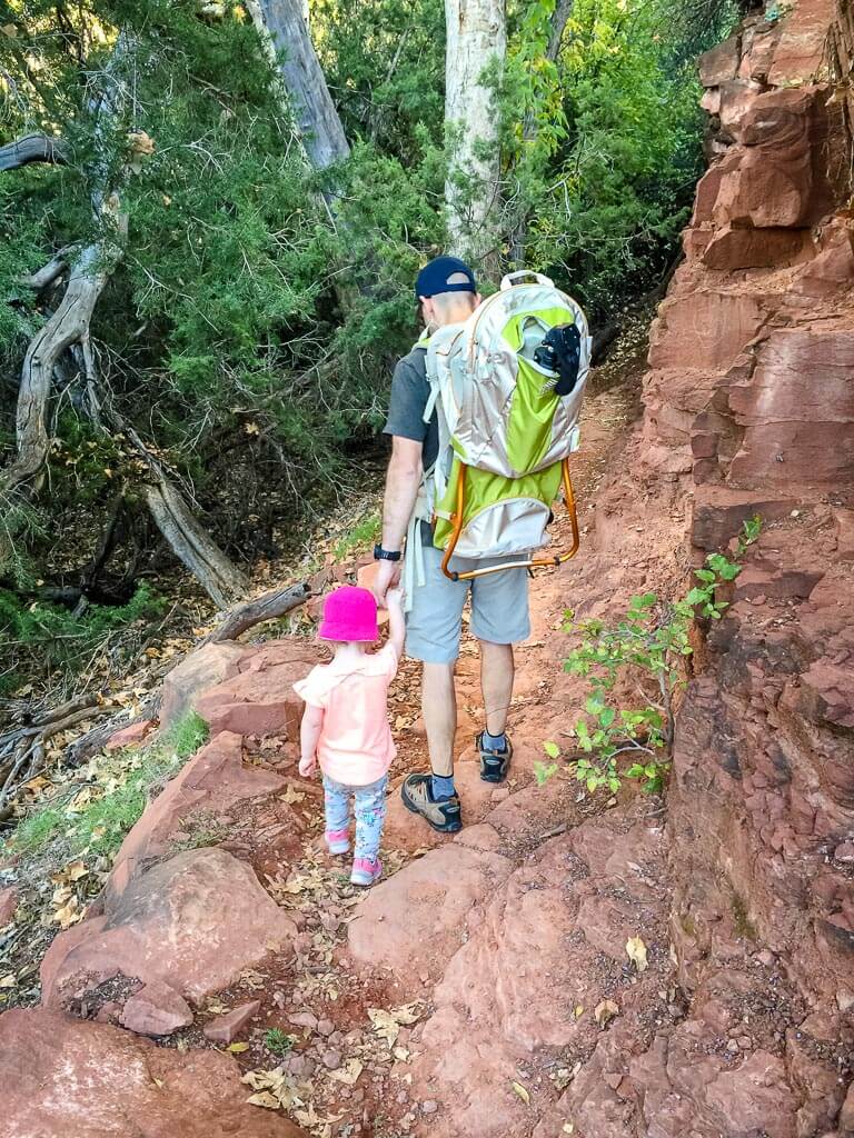 Dan Brewer, of BabyCanTravel.com, hikes on the Baldwin Trail in Sedona, AZ with his toddler and an infant in a backpack carrier.