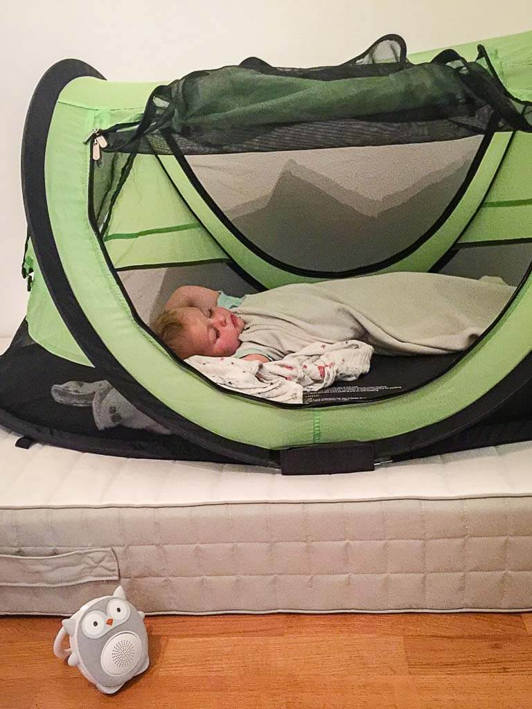 a baby from the BabyCanTravel.com family uses a portable sound machine for sleeping on a family vacation.