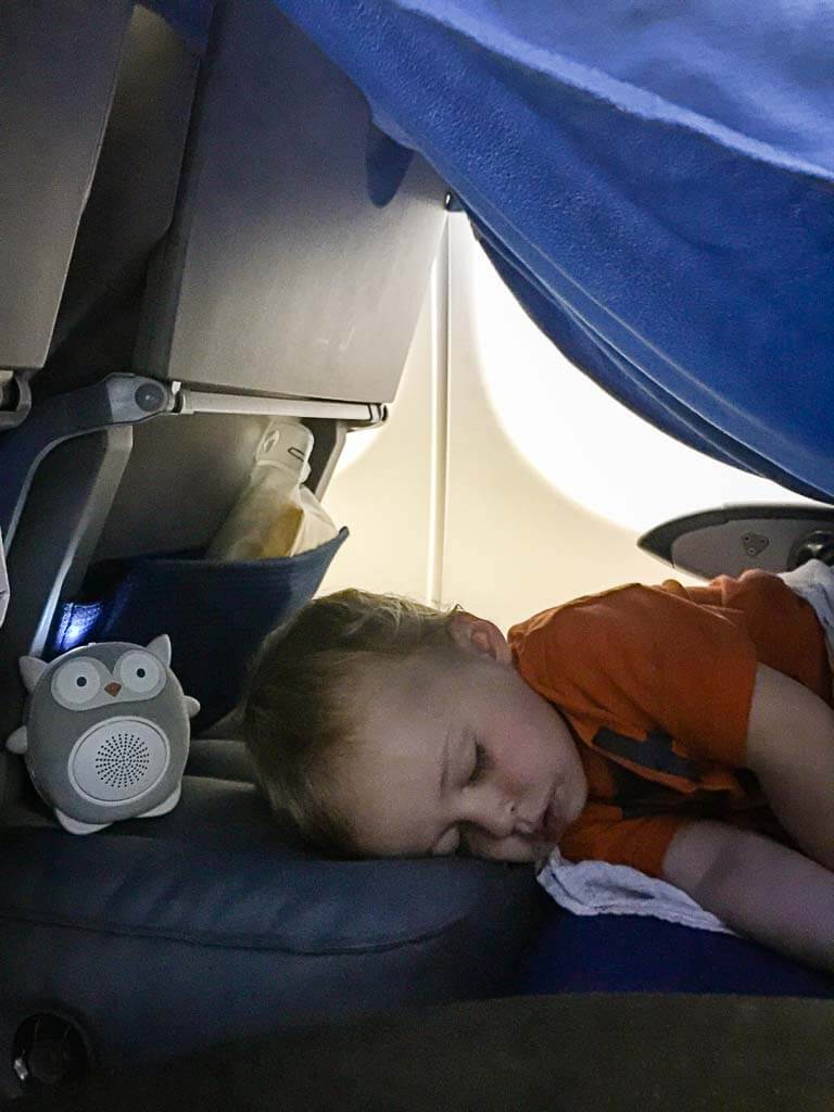 One of the toddlers from the Baby Can Travel family uses a white noise machine to sleep on an airplane.