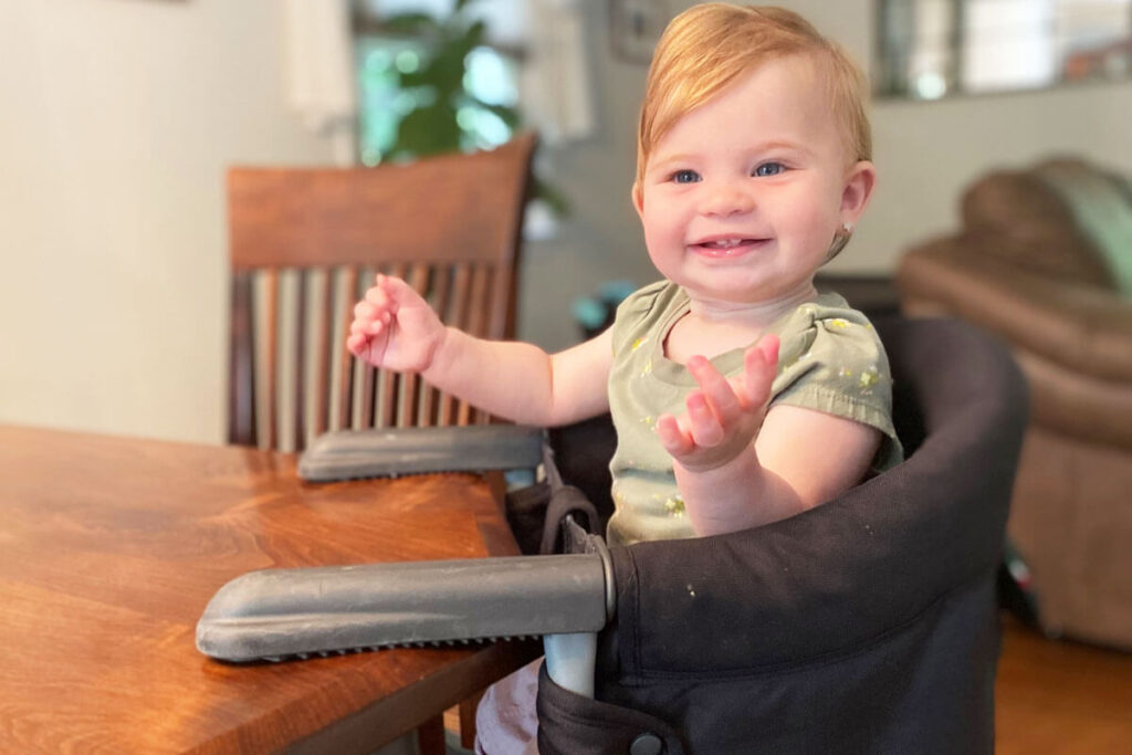 baby sitting in Inglesina Fast Table Chair - hook on high chair that attaches to table