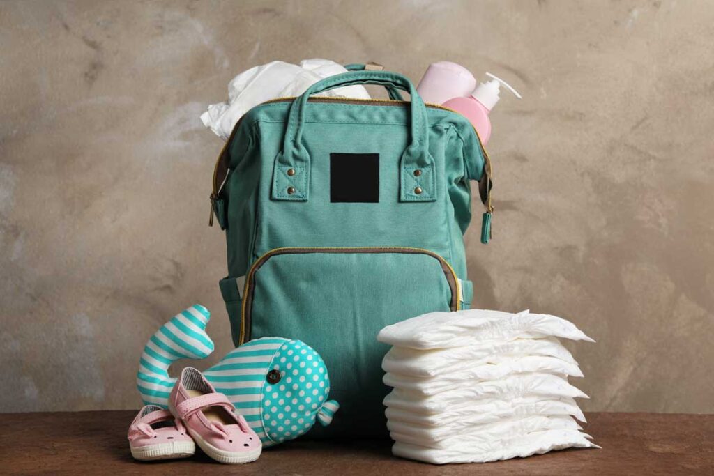 best backpack baby diaper bag surrounded by diapers and baby essentials