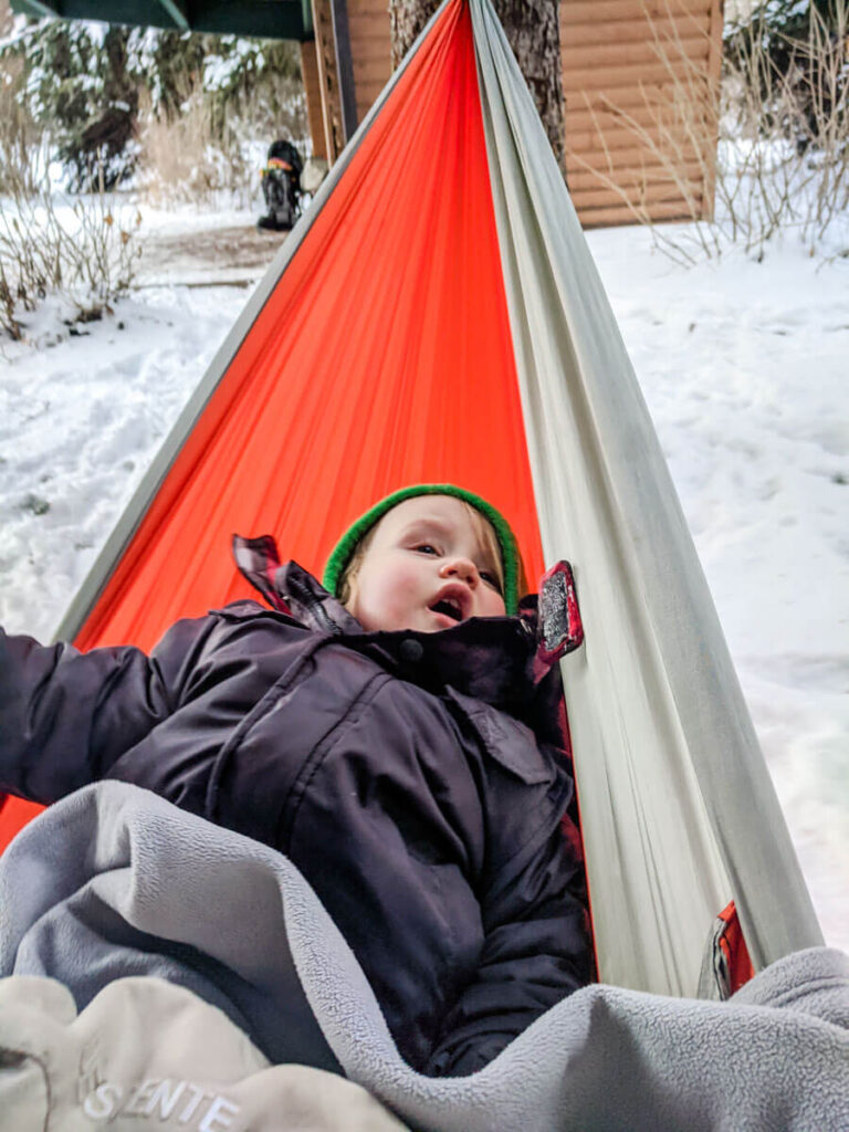 toddler in hammock - cold weather camping with a toddler