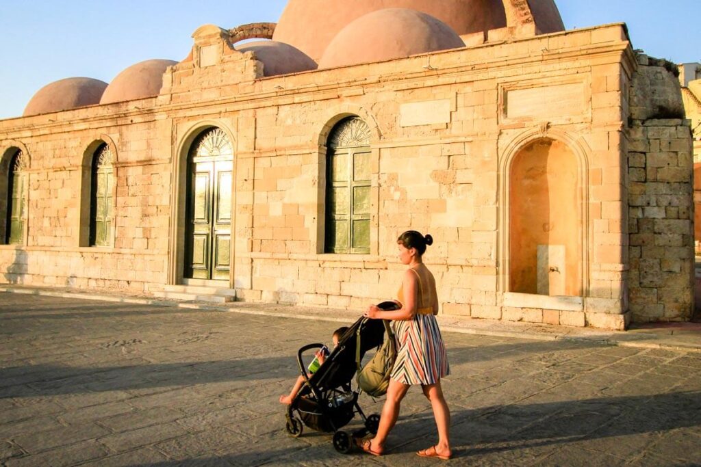 Mother pushing inglesina baby stroller on a family vacation to Europe.