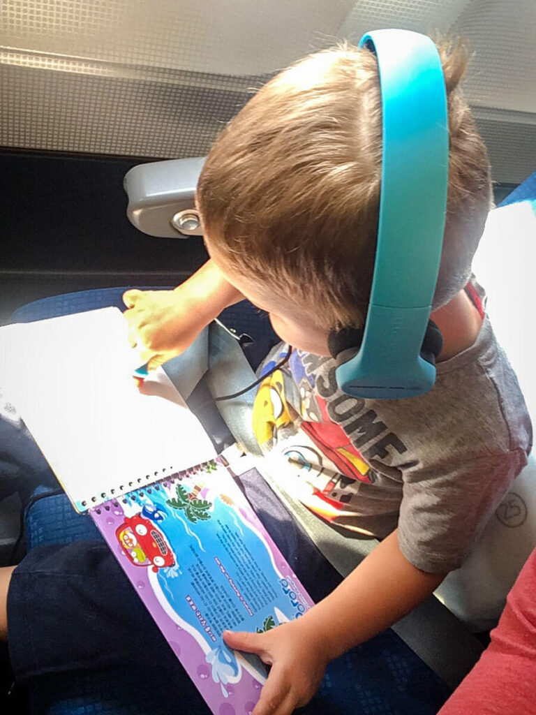 flying with toddler wearing best headphones for a toddler.