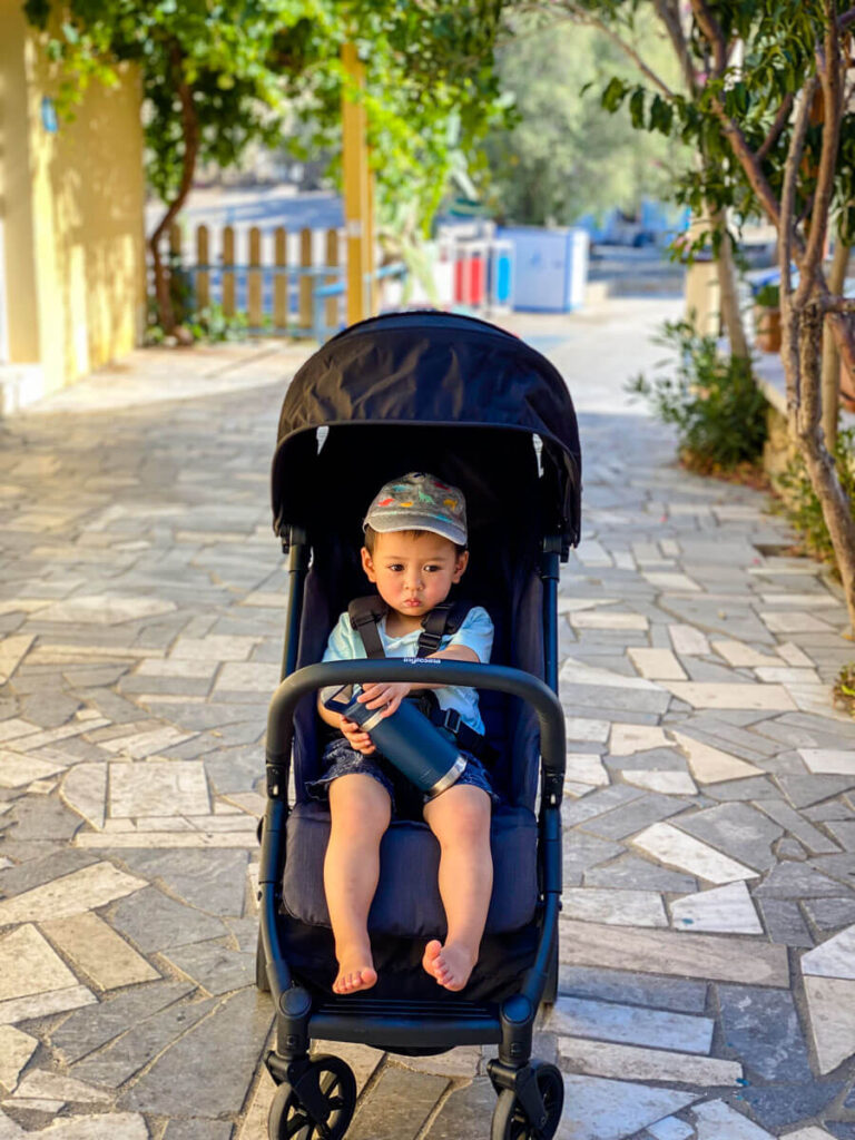 Toddler sitting in Inglesina Quid - compact folding stroller.