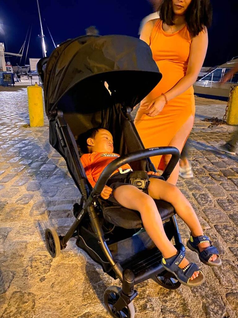 toddler asleep in Inglesina stroller while on a family vacation to Greece,