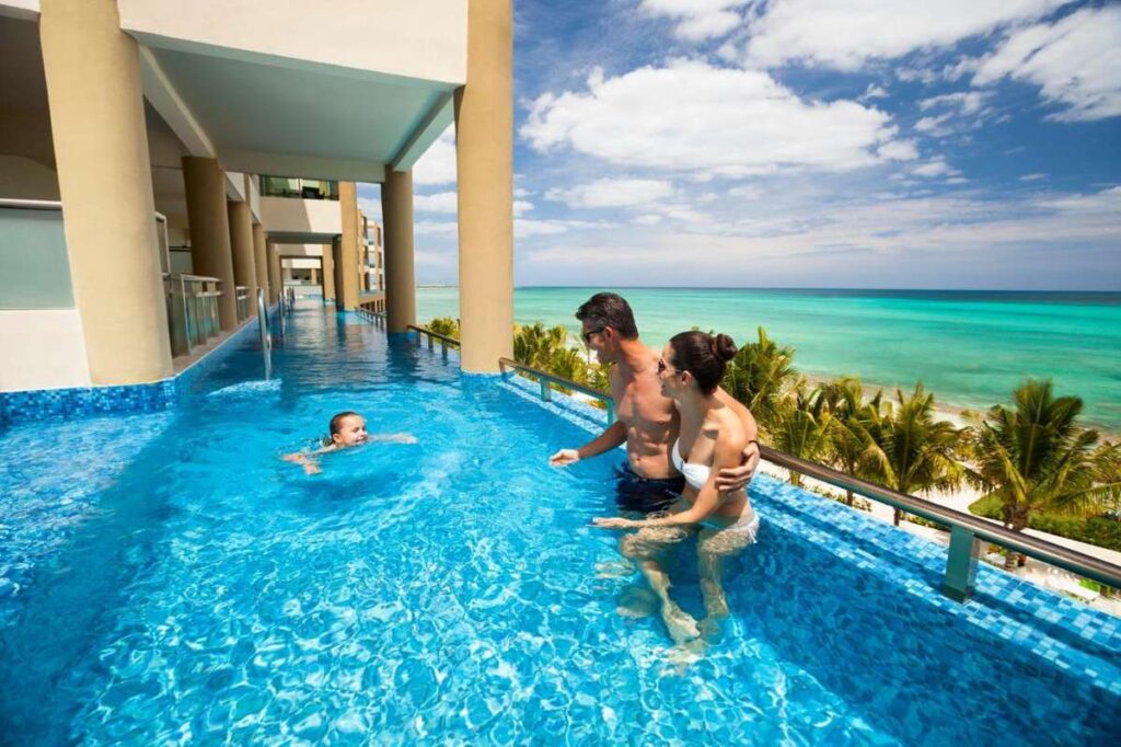 a child swims in their private pool at the Generations Riviera Maya resort - family-friendly vacations in Mexico at an all-inclusive resort.