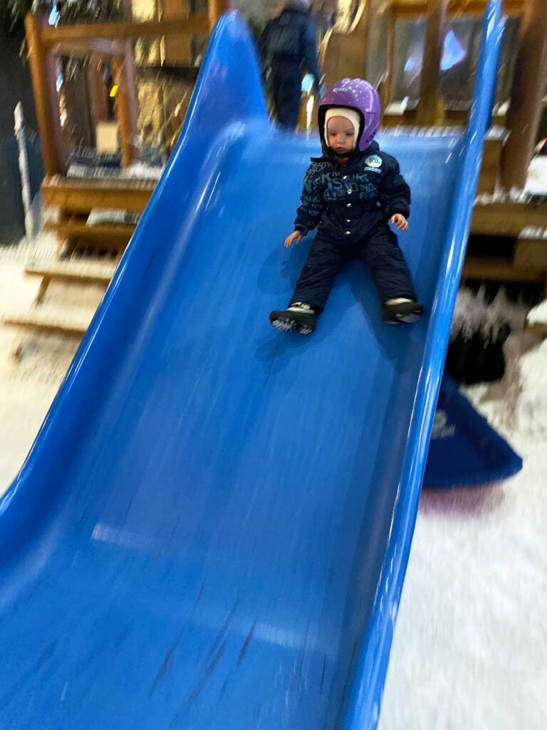 Ski Dubai with a toddler going down a slide