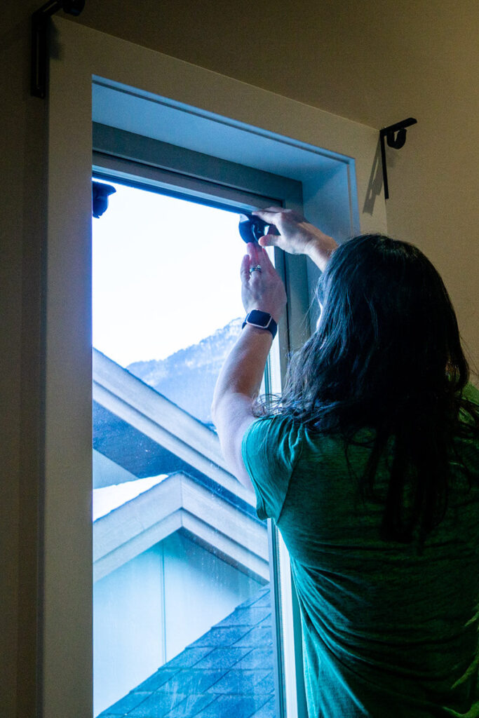 Installing Sleepout curtains with suction cups on a window