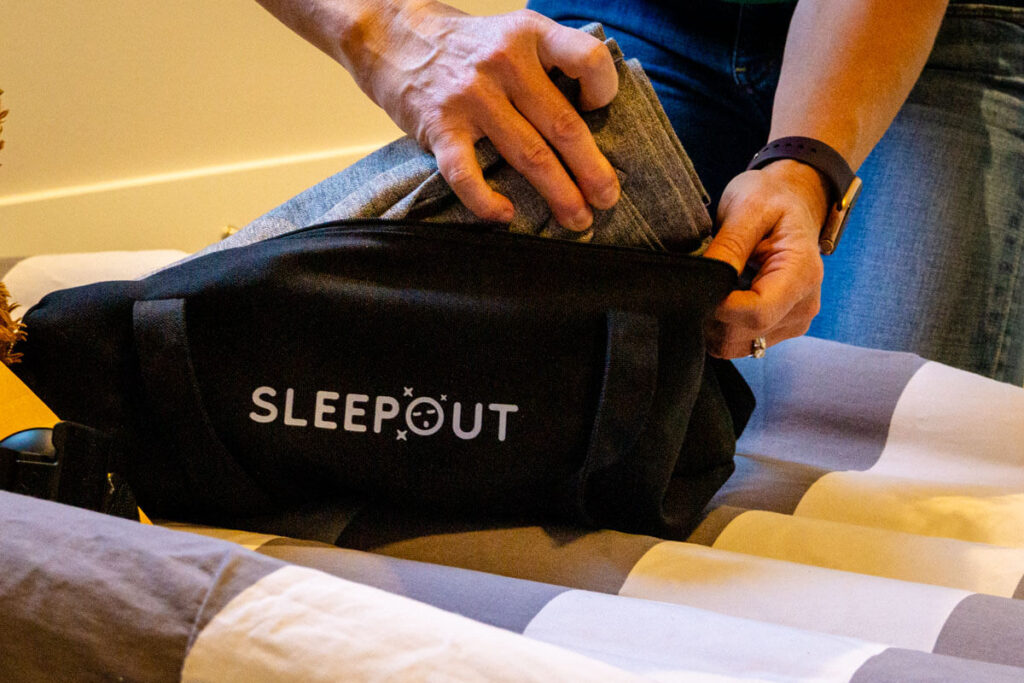 putting Sleepout travel blackout blinds into travel bag