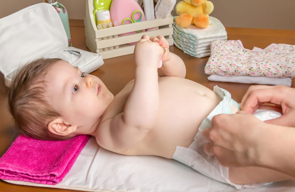 baby getting diaper change on travel change mat