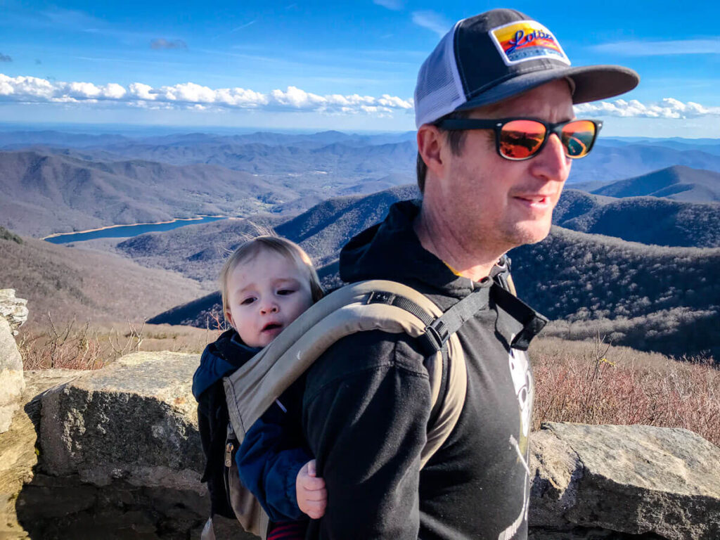 father carry baby in carrier on back - Hikes Near Asheville with a Baby