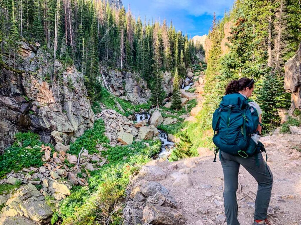 woman with backpack on Sky Pond Hike - Rocky Mountain National Park hikes