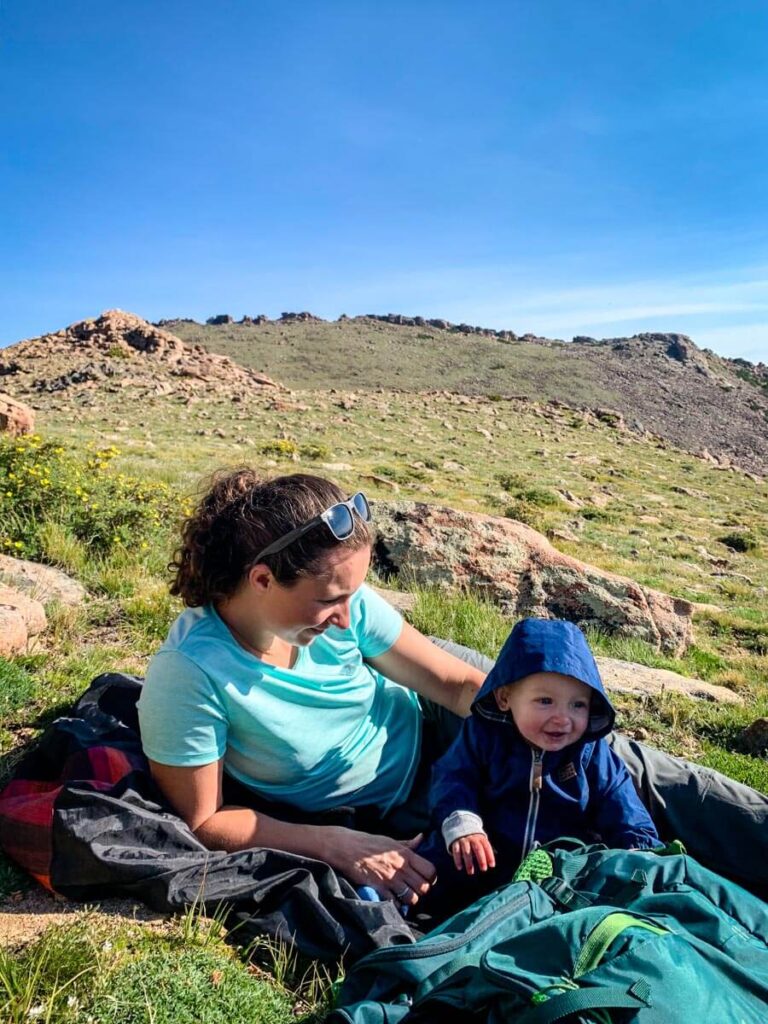 Mother and baby on picnic blanket on Ute Trail Hike - Rocky Mountain National Park with a Baby