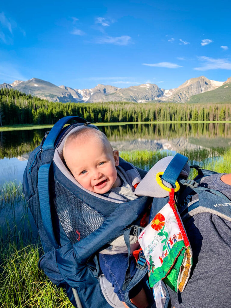 smiling baby in hiking backpack carrier