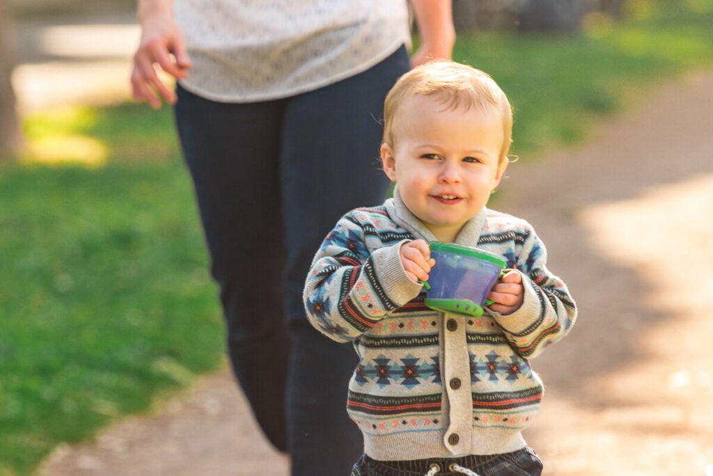 toddler walking with spill proof snack cup