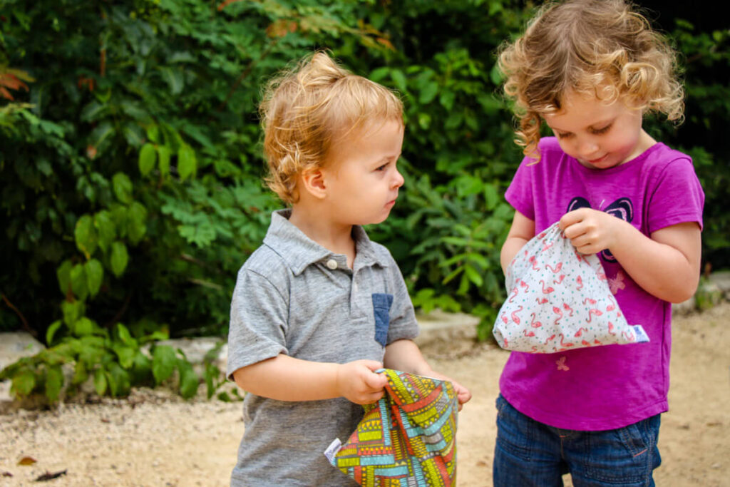 toddlers holding snack containers for toddlers