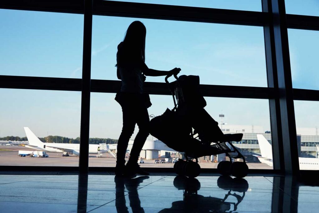 woman with travel stroller at airport