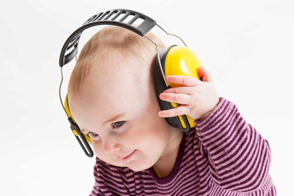 Baby wearing yellow baby noise canceling headphones