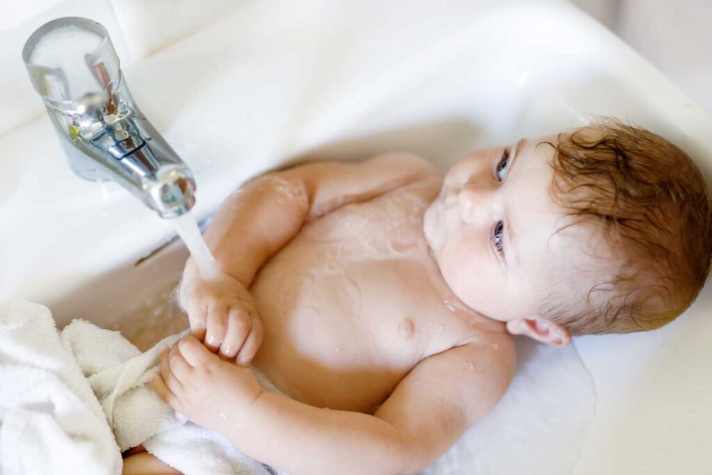 bathing baby in sink on vacation