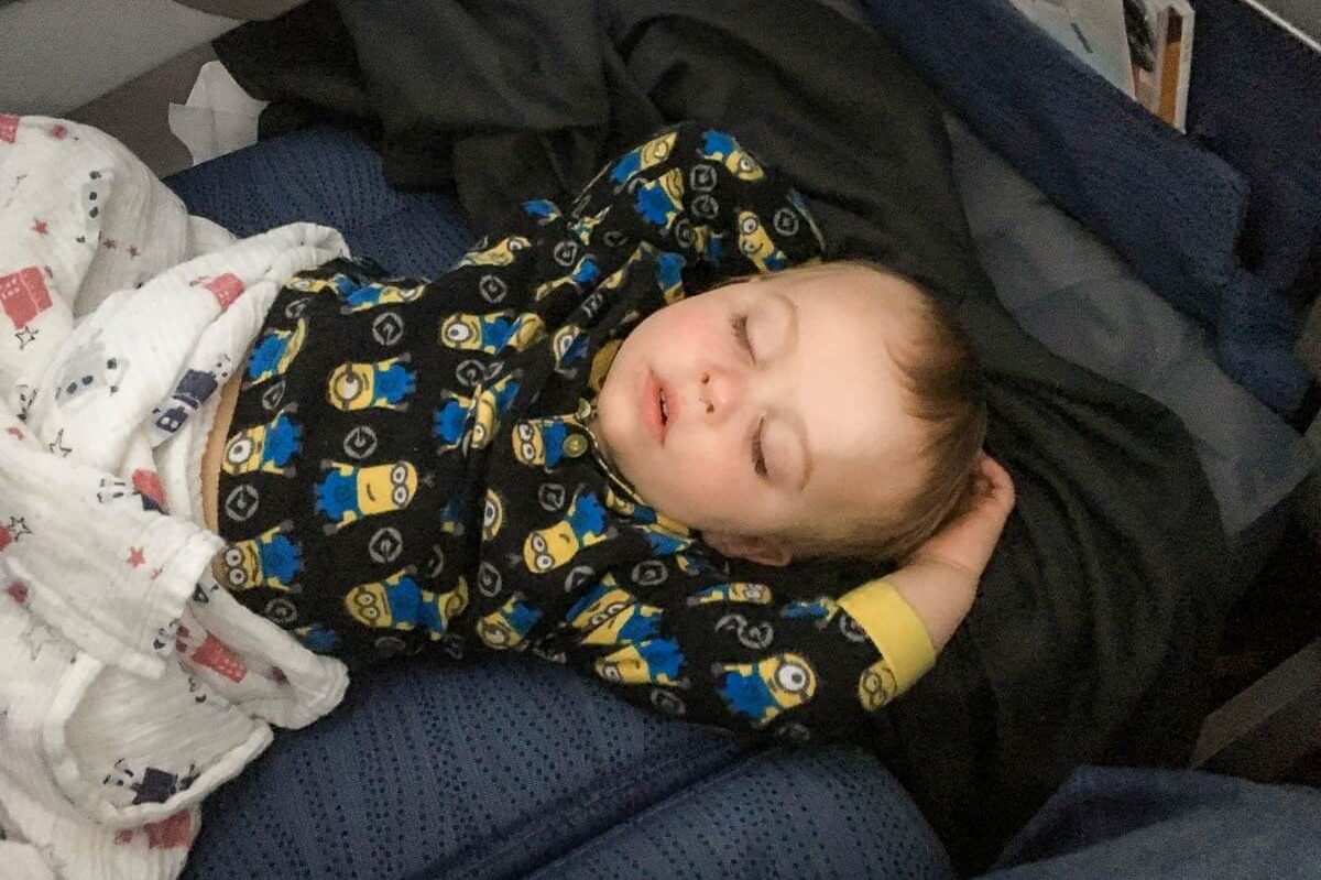 image of toddler sleeping on plane