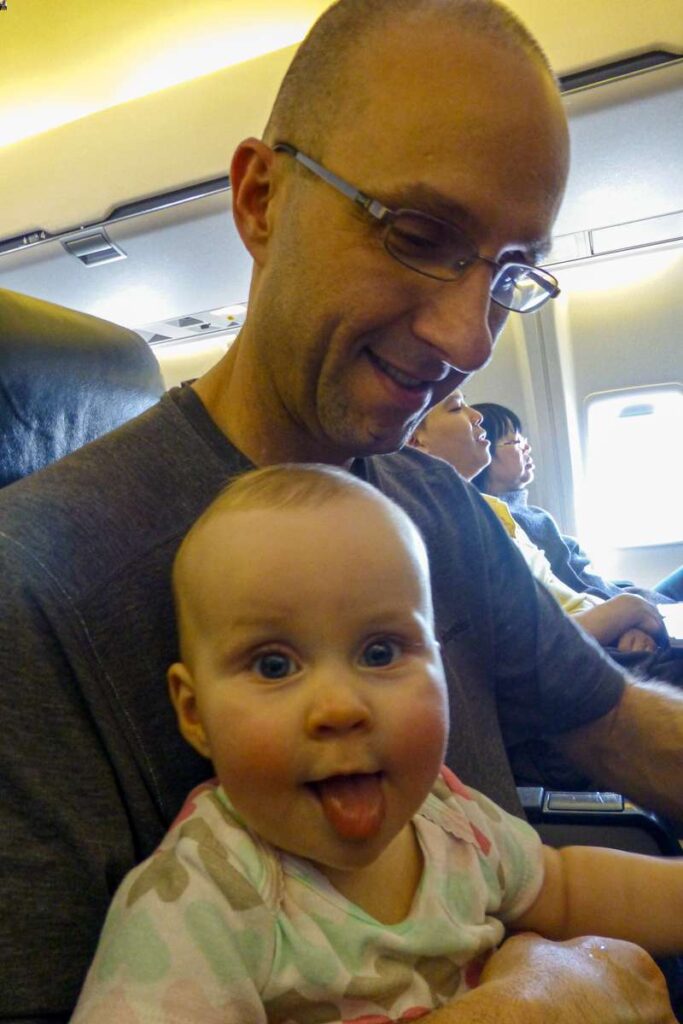 a father with his baby on a plane