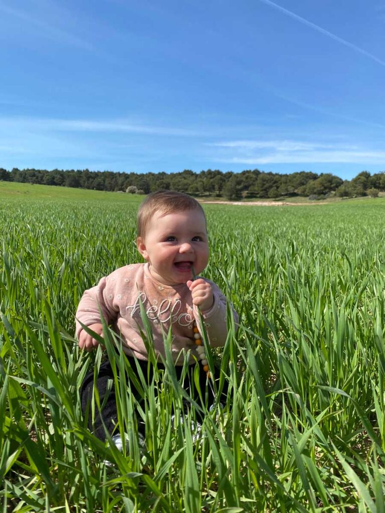 baby sitting in grass at Masseria Chinunno - places to stay in Puglia with a baby