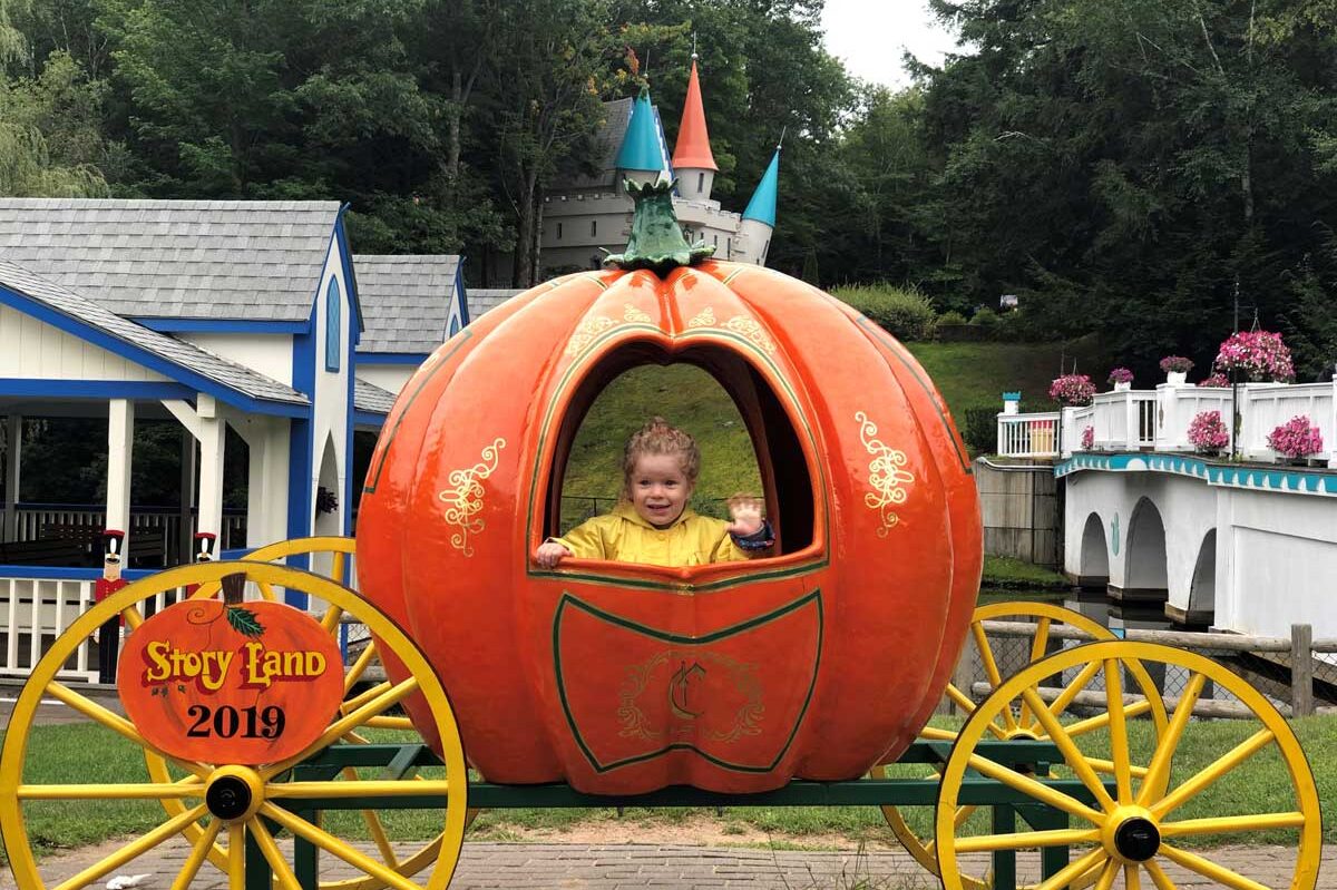 image of toddler in pumpkin coach at Story Land