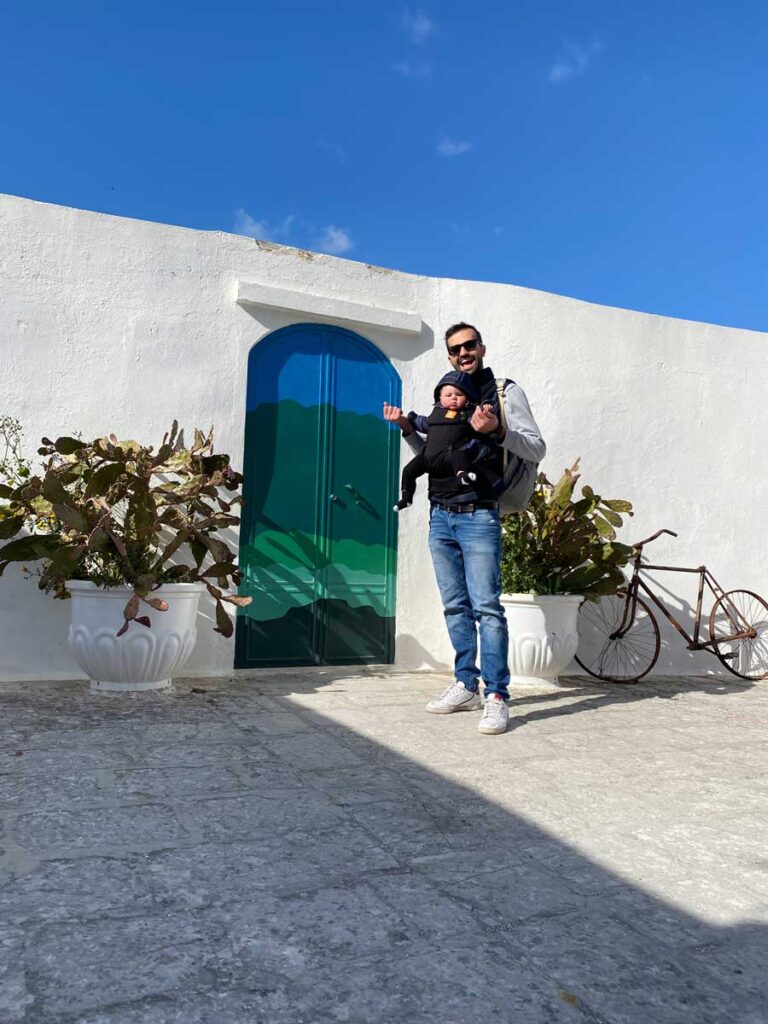 Man with baby in baby carrier in Ostuni