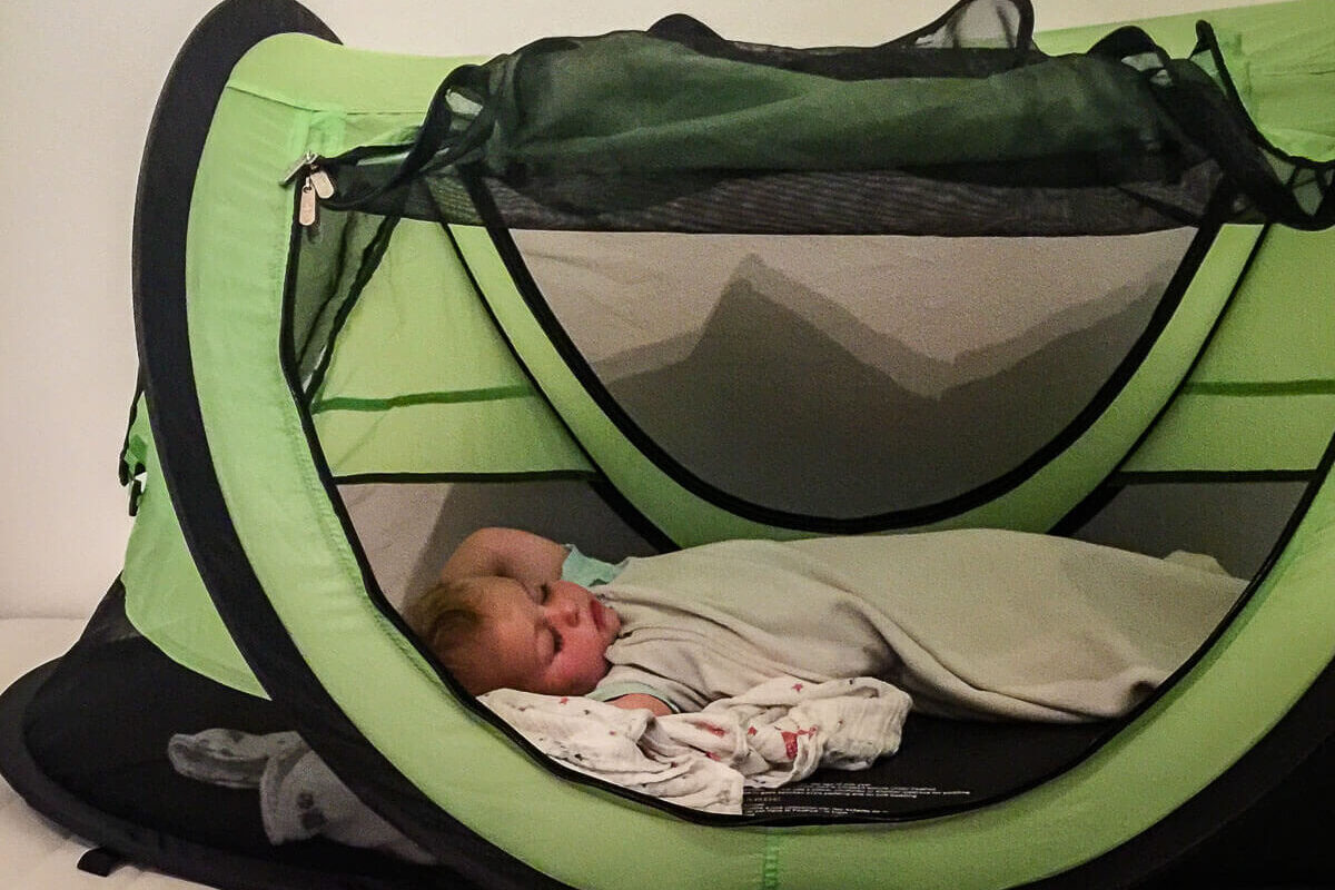 Toddler sleeping in KidCo PeaPod Plus travel tent