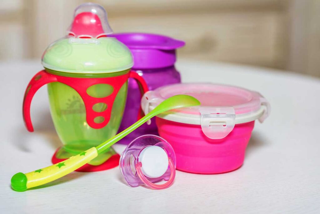 a snack cup and sippy cups for camping with a baby.