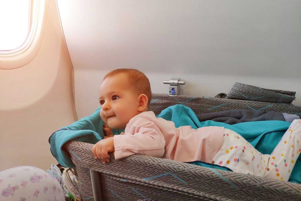 a baby in bassinet in flight.