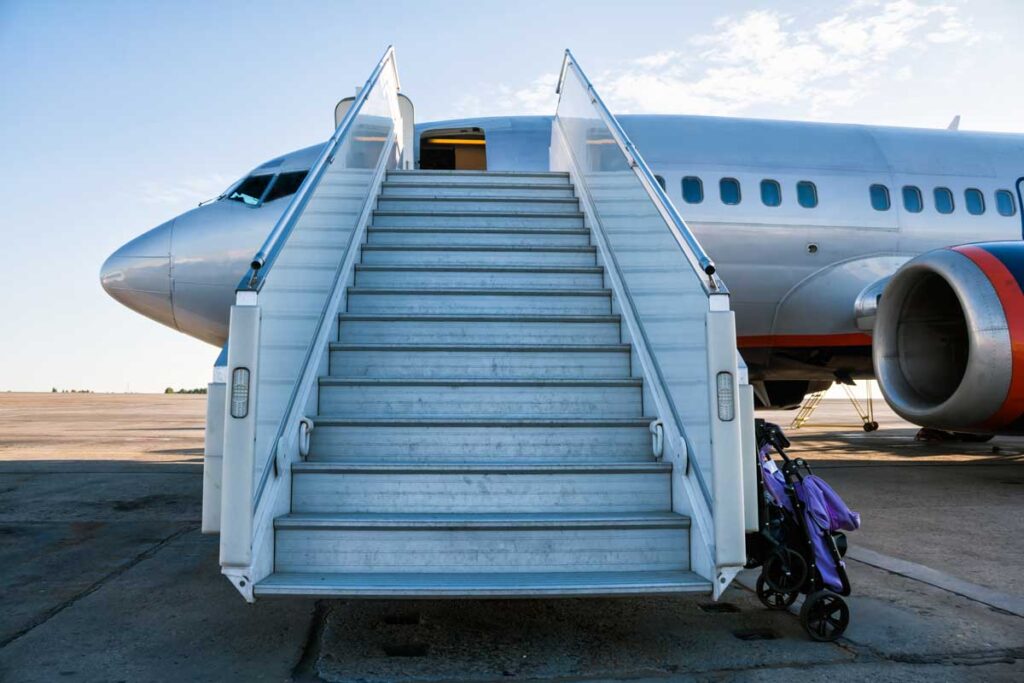 a gate checked stroller near an airplane