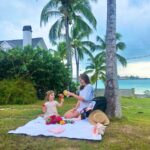 Woman and toddler having a picnic on a tropical island, using Getaway bag as a picnic bag