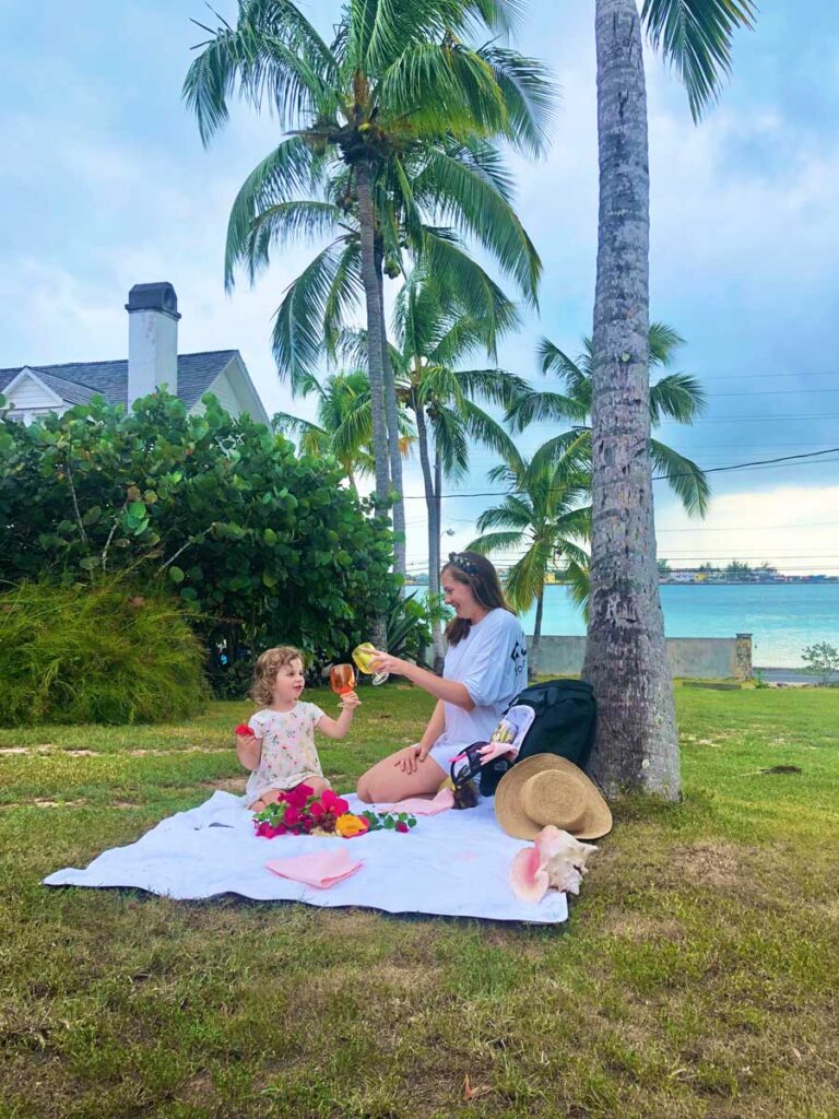 Woman and toddler having a picnic on a tropical island, using Getaway bag as a picnic bag