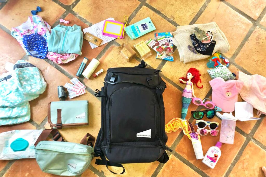 No Reception Club Getaway Bag and Sidekick surrounded by baby essentials to pack into it