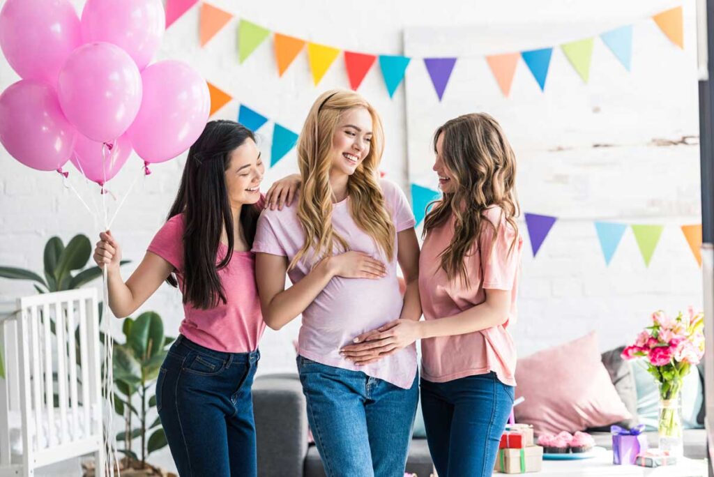 two friends make a mom-to-be feel special at her baby shower party