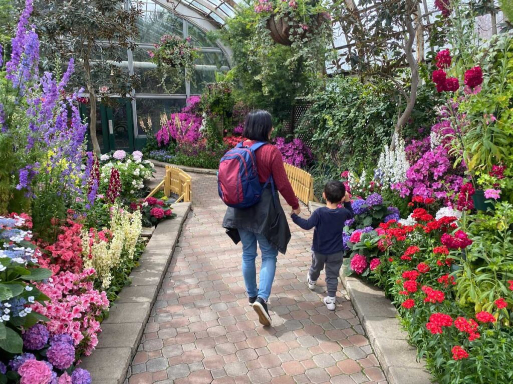 mother and toddler walking through Lincoln Park Conservatory in Chicago