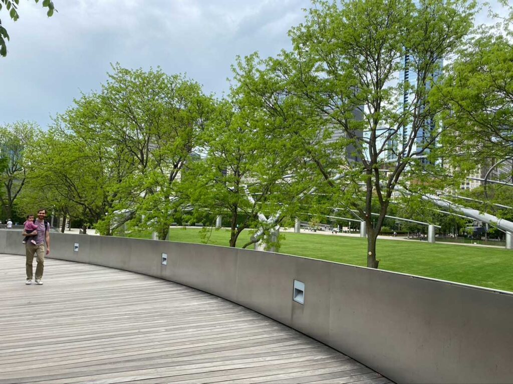 father with baby in carrier in Millennium park Chicago