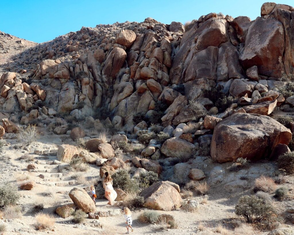 rock boulder with toddlers running amongst them