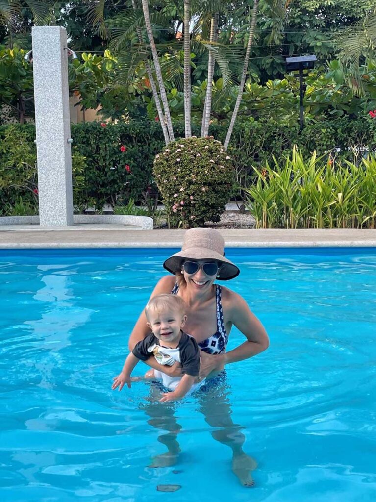 woman in pool holding baby in Costa Rica