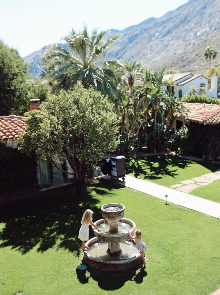 toddlers playing near fountain at airbnb in Palm Springs